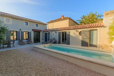 a villa with a swimming pool and a house at Mas provençal au coeur de L'Isle-sur-la-Sorgue in LʼIsle-sur-la-Sorgue