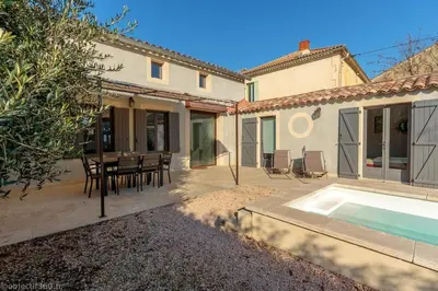 a house with a patio and a swimming pool at Mas provençal au coeur de L'Isle-sur-la-Sorgue in LʼIsle-sur-la-Sorgue