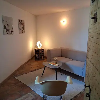 a living room with a couch and a table at gîtes carita in Cabannes