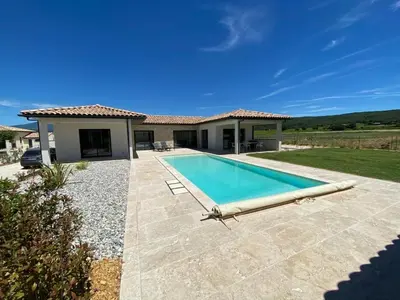 a villa with a swimming pool in front of a house at Villa with pool in Provence bij de Mont Ventoux in Blauvac