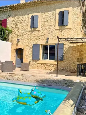 a house with a swimming pool in front of a building at Mas Bourbon in Cavaillon