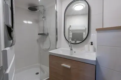 a bathroom with a sink and a mirror at Studio climatisé plein centre 4eme étage in Aix-en-Provence