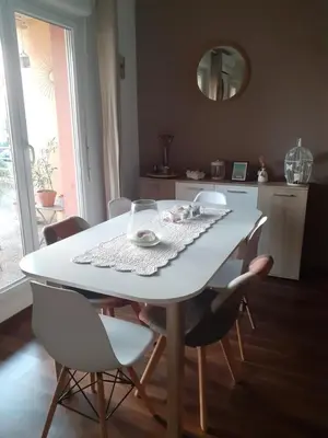 a white dining room table with chairs and a mirror at Bichette in Cavaillon