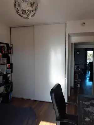 a living room with a sliding door and a chair at Bichette in Cavaillon