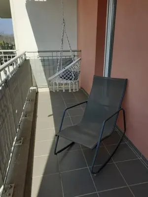 a hammock and a chair on a balcony at Bichette in Cavaillon