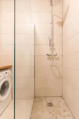 a shower stall with a washing machine in a bathroom at T3 proche cardeurs clim centre ville in Aix-en-Provence
