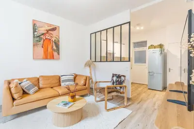 a living room with a couch and a table at T3 proche cardeurs clim centre ville in Aix-en-Provence