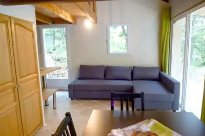 a bedroom with a bed and a table with a lamp at Gîte du Jonquas in Velleron