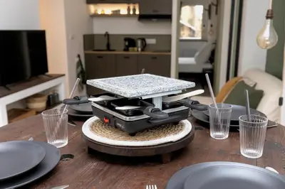 a table with plates and a food scale on it at Suite Vert Provence - Hypercentre - Wifi in Apt