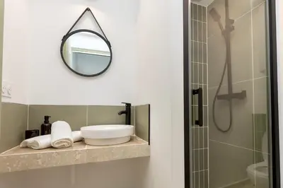 a bathroom with a sink and a mirror at Suite Vert Provence - Hypercentre - Wifi in Apt
