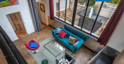 an overhead view of a living room with a blue couch at Aix-en-Provence, Centre ville quartier Mazarin, magnifique loft in Aix-en-Provence