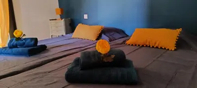a bedroom with a bed with two pillows on it at Le Refuge des Cigalons in Cavaillon