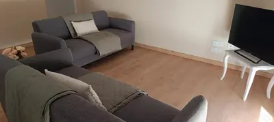 a living room with a couch and a tv at Le Refuge des Cigalons in Cavaillon