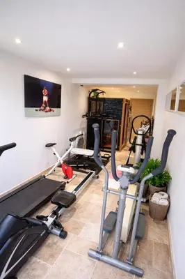 a gym with treadmills and exercise bikes in a room at Bienvenue à la villa Bellavista in Pertuis