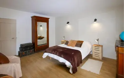 a bedroom with a bed and a dresser and a mirror at Amazing Home In Lagnes in Lagnes
