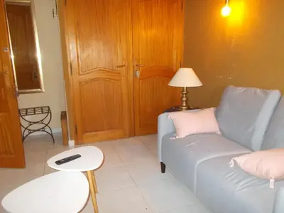 a living room with a couch and a table at Tramontane chambre salon et piscine in Jonquerettes