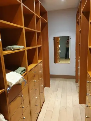 a room with wooden shelves and a person in a mirror at Mas spacieux Les Agasses calme - Isle sur sorgue in LʼIsle-sur-la-Sorgue