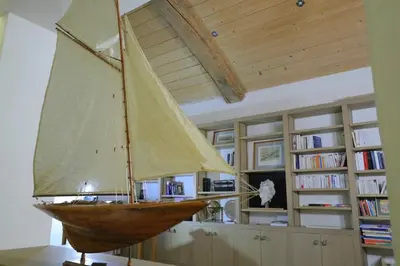 a wooden sail boat on display in a room at Mas spacieux Les Agasses calme - Isle sur sorgue in LʼIsle-sur-la-Sorgue