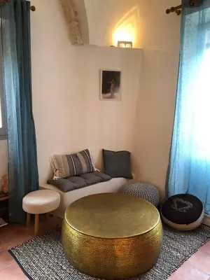 a living room with a couch and a table at studio au coeur de Lacoste in Lacoste