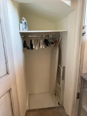 a closet with shoes hanging on a rack at Le Sainte-Victoire - Studio cosy avec sa jolie terrasse - Centre ville historique in Aix-en-Provence
