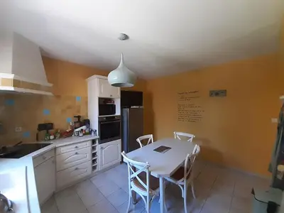 a kitchen with a table and chairs in it at 4 bedroom villa pool entire place in Salon-de-Provence