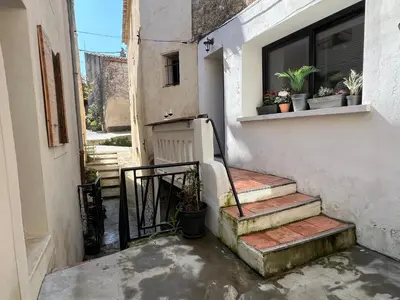 an alley with stairs and a window and potted plants at Maison cosy en Provence Proche Golf Pont Royal in Alleins