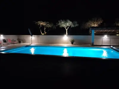 a swimming pool at night with lights at Close to Saint-Rémy-de-Provence in Eyragues
