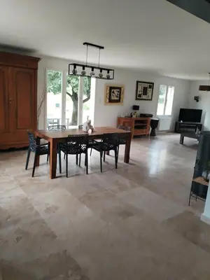 a living room with a wooden table and chairs at Close to Saint-Rémy-de-Provence in Eyragues
