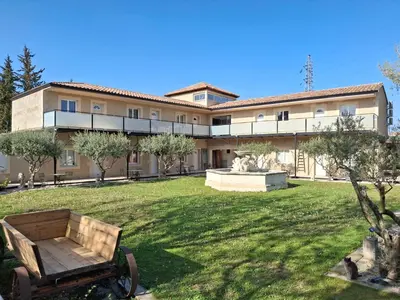 a large building with a park in front of it at Mas d'Andiol in Plan-dʼOrgon