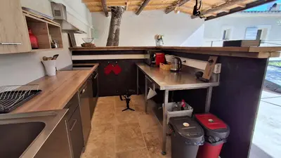 a kitchen with a counter and a table in it at Mas d'Andiol in Plan-dʼOrgon