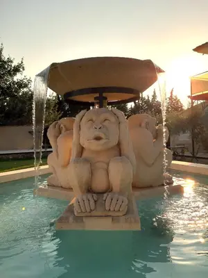 a statue of a monkey sitting in a swimming pool at Mas d'Andiol in Plan-dʼOrgon
