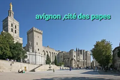 a building with two towers and people walking around it at Maison de village rénovée au pied des alpilles in Mollégès