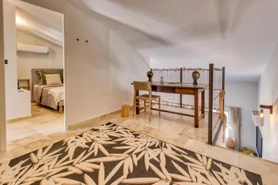 a bedroom with a bed and a desk in a room at VILLA Isle sur la Sorgue in LʼIsle-sur-la-Sorgue