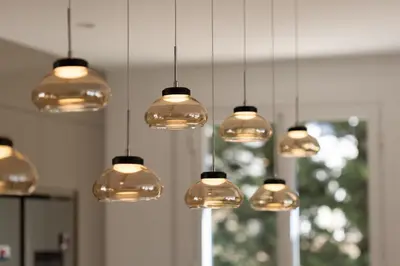 a bunch of lights hanging from a ceiling at La Villa L'Isle-St-Antoine piscine chauffée in LʼIsle-sur-la-Sorgue