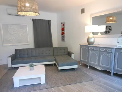 a living room with a couch and a table at Bastide De La Lézardière in Fontaine-de-Vaucluse