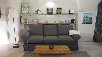 a living room with a couch and a table at Le LOFT LOURMARIN in Lourmarin