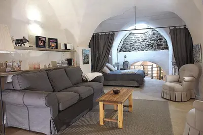 a living room with a couch and a table at Le LOFT LOURMARIN in Lourmarin