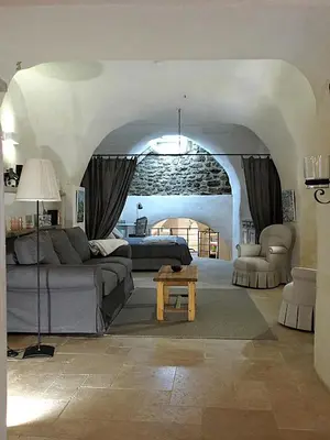 a living room with a couch and a table at Le LOFT LOURMARIN in Lourmarin