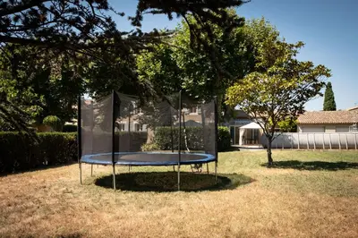 a trampoline in the grass in a yard at La maison du bonheur in Pélissanne