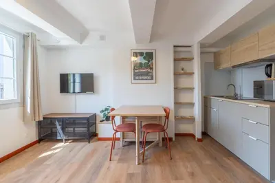 a kitchen and dining room with a table and chairs at Studio climatisé plein centre 3eme étage in Aix-en-Provence