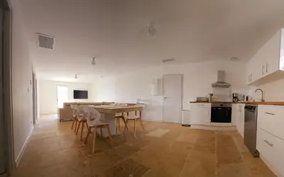 a kitchen and dining room with a table and chairs at L' Aglandau Au coeur des oliviers en Provence in Pélissanne