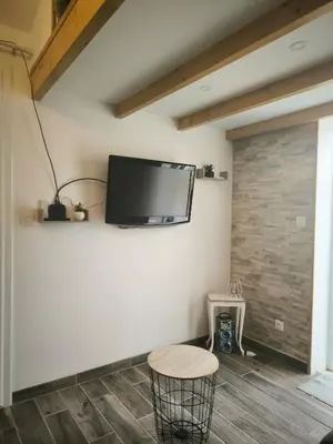 a living room with a tv on the wall at Logement 2 personnes in Morières-lès-Avignon