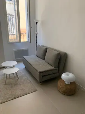 a living room with a couch and a table at Studio au cœur d Aix en Provence in Aix-en-Provence