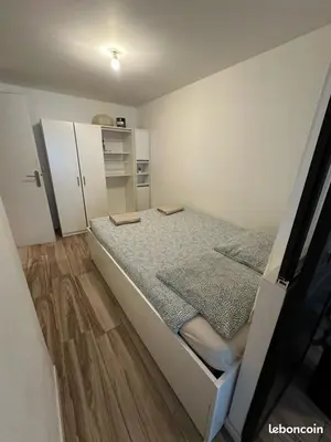 a small bedroom with a large bed in it at L'escapade aixoise in Aix-en-Provence