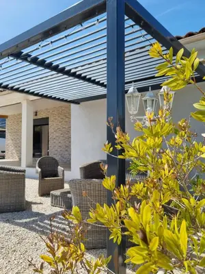 a kitchen and dining room with a table and refrigerator at Maison du Luberon in Maubec