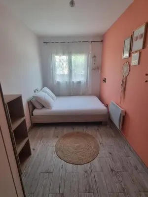 a bedroom with a bed in a room with a window at Maison du Luberon in Maubec