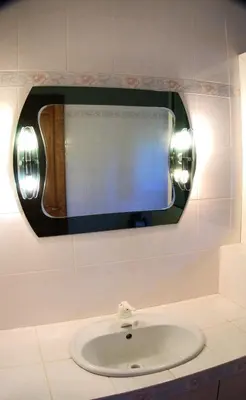 a bathroom with a sink and a mirror on the wall at Villa provençale 4 chambres à Aix en Provence in Aix-en-Provence