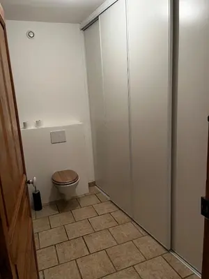 a bathroom with a toilet and a cabinet at Charmante maison de village dans le Luberon in Beaumont-de-Pertuis