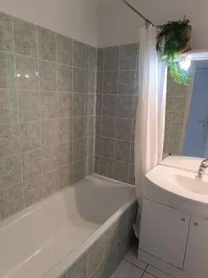 a bathroom with a bath tub and a sink at La Cigale d'Avignon in Saint-Saturnin-lès-Avignon