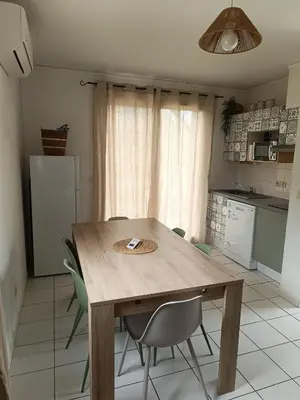 a patio with a table and chairs in front of a house at La Cigale d'Avignon in Saint-Saturnin-lès-Avignon